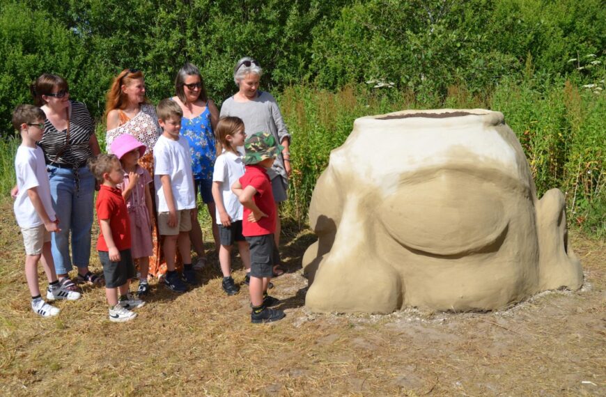 Giant plant pot head sculpture takes root at community centre
