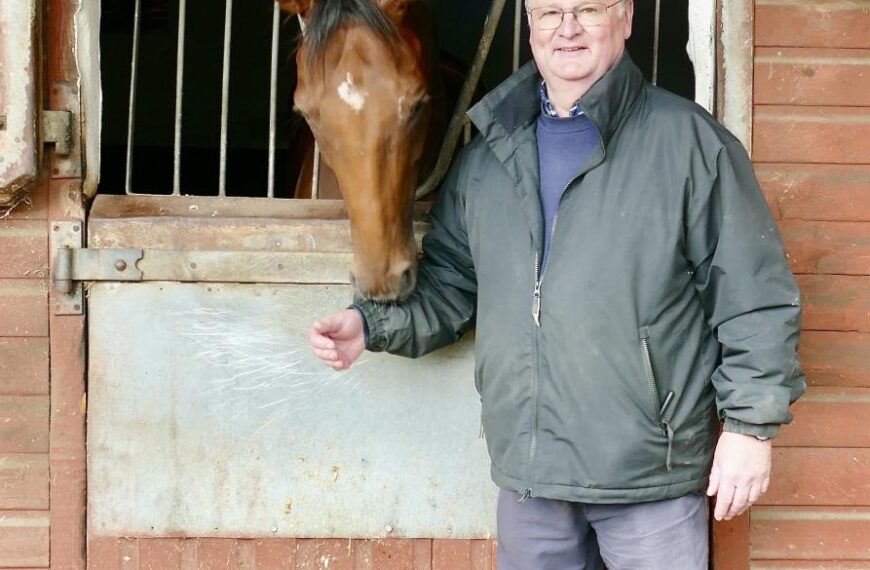 Trainer opens the stable door to show a thoroughbred level of care